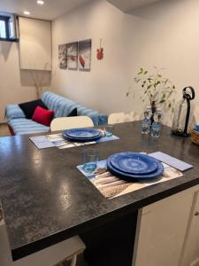 a kitchen with a counter with blue plates on it at BASSA MAREA in Gaeta +17 photos