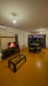 a living room with a table and a tv at Departamento MeR in Río Cuarto +8 photos