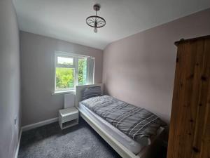 a bedroom with a bed and a window at Elim House in Birmingham