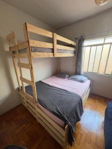 a bedroom with a bunk bed with a ladder at Pousada Dois Irmãos in Uberaba