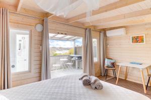 a bedroom with a bed and a table and a desk at The Tawnys Gatehouse in Russell