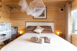 a bedroom with a bed with two towels on it at The Tawnys Gatehouse in Russell