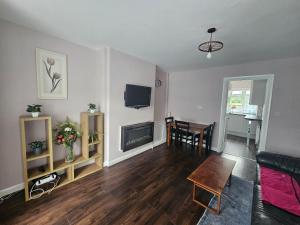 a living room with a couch and a table at Elim House in Birmingham