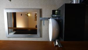 a mirror on a wall next to a sink at Gold Palace Hotel in San Juan de los Lagos