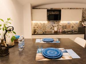 a table with blue plates on it in a kitchen at BASSA MAREA in Gaeta
