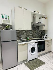 a kitchen with a washing machine and a dishwasher at Il filo di Claudia in Savona