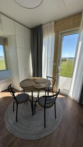 a table and chairs in a room with a window at EkoHniezdo Slovenský Raj in Smižany