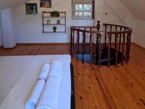 a bedroom with a wooden floor and a spiral staircase at KiteBay Villa in Rákhai +9 photos