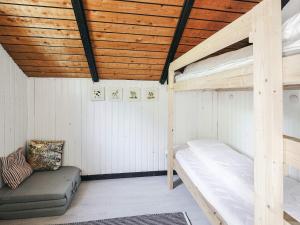 a room with two bunk beds and a couch at 4 star holiday home in Gørlev in Gørlev +20 photos