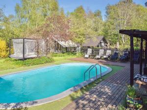 a swimming pool in a yard with a house at 4 star holiday home in Gørlev in Gørlev