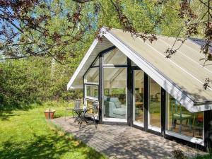 a conservatory with a white roof on a patio at 4 star holiday home in Gørlev in Gørlev