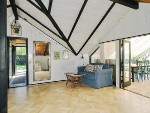 a living room with a blue couch and a table at 4 star holiday home in Gørlev in Gørlev