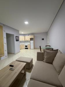 a living room with a couch and a table at Mamma's Apartments in Sarandë