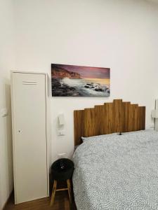 a bedroom with a bed and a picture on the wall at Il filo di Claudia in Savona +13 photos