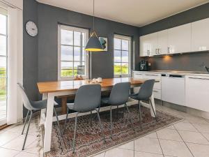 a kitchen with a dining room table and chairs at 8 person holiday home in Bogense-By Traum in Bogense