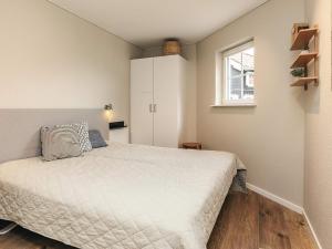 a small bedroom with a bed and a window at 8 person holiday home in Bogense-By Traum in Bogense