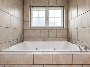 a bath tub in a bathroom with a window at 8 person holiday home in Bogense-By Traum in Bogense +22 photos