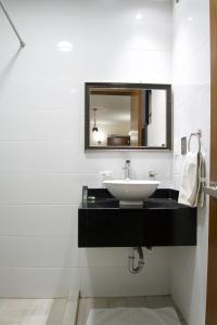 a bathroom with a sink and a mirror at Gold Palace Hotel in San Juan de los Lagos +32 photos