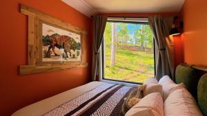a bedroom with a window and a bed in a room at Bison Farm - Cabin "Loma" in Culpeper