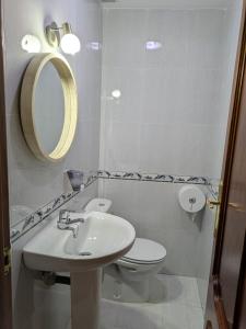 a bathroom with a sink and a toilet and a mirror at At - Anita in La Alberca +8 photos