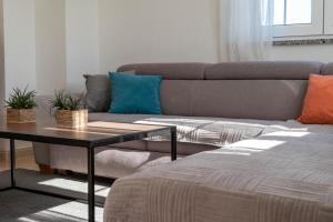 a living room with a couch and a table at Apartman Ika Umag in Umag