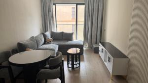 a living room with a couch and a table at Leo residences 1 in Eldoret