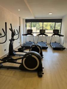 a gym with several tread machines in a room at Leo residences 1 in Eldoret