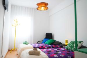 a bedroom with two beds and a table at Horta Joy! in Horta