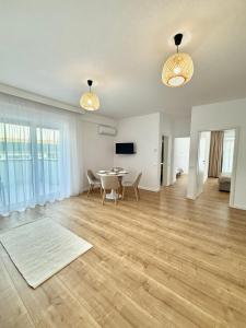 a large living room with a table and chairs at Elegance Apartments in Baile Felix