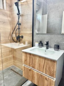 a bathroom with a sink and a shower at Elegance Apartments in Baile Felix +23 photos
