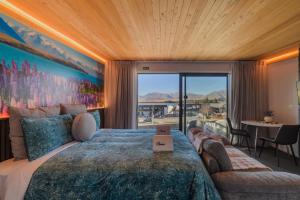 a bedroom with a large bed and a large window at Aurora Vista - Ohana in Lake Tekapo