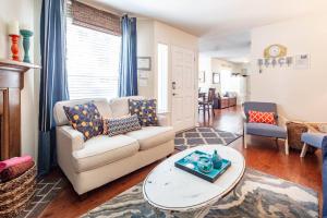 a living room with a couch and a table at Herons' Haven in Charleston