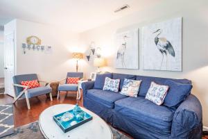 a living room with a blue couch and chairs at Herons' Haven in Charleston