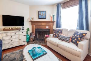 a living room with a couch and a fireplace at Herons' Haven in Charleston +42 photos