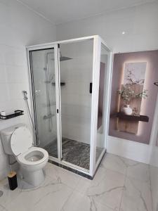 a bathroom with a toilet and a glass shower at Tina Bay in Mindelo +30 photos