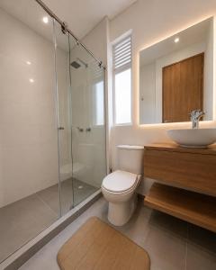 a bathroom with a toilet and a sink and a shower at Casa Edén 95 in Ricaurte +2 photos