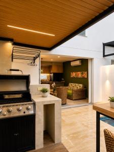 a kitchen with a stove and a living room at Casa Edén 95 in Ricaurte