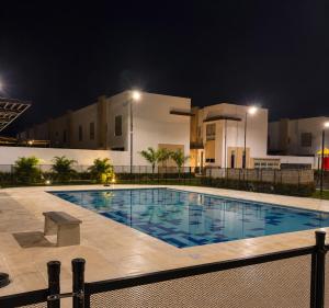 a swimming pool in front of a building at night at Casa Edén 95 in Ricaurte