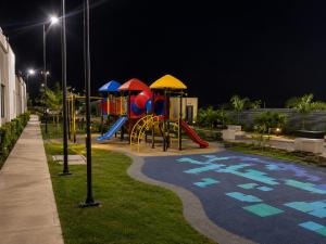 a park with a playground at night at Casa Edén 95 in Ricaurte