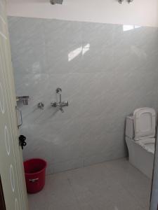 a bathroom with a shower and a toilet at Hotel Badri Palace in Rishīkesh