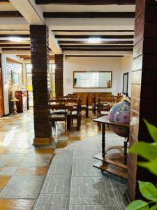 a room with tables and chairs and a large screen at Hotel Boutique Casa Piedra in Tocopilla