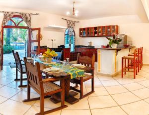a kitchen and dining room with a table and chairs at Tranquil Middle Apartment in Mtwapa