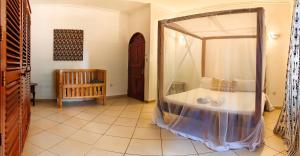 a bedroom with a bed with a large mirror at Tranquil Middle Apartment in Mtwapa +37 photos