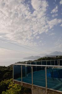 a balcony of a building with a view of the mountains at Blue Horizon Villa DV in Dobra Voda