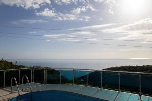 a view of the ocean from the balcony of a house at Blue Horizon Villa DV in Dobra Voda