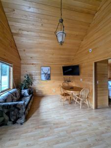a living room with a couch and a table at NV Mountainview Chalets & RV Resort in McBride