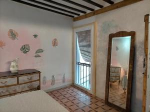 a bedroom with a mirror and a dresser at Casona Los Infantes in Villanueva de los Infantes