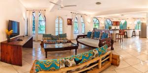 a living room with a couch and a table at Penety Villa in Shanzu