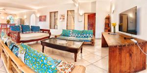 a living room with couches and a coffee table at Penety Villa in Shanzu