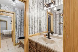 a bathroom with a sink and a mirror at The Lodge at Duck Creek in Duck Creek Village +122 photos